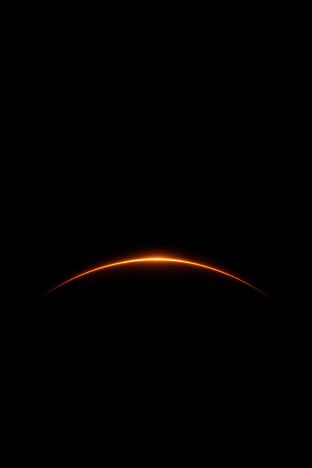 Dark minimal OLED phone wallpaper — single thin luminous amber arc on pure black background, vertical 4K